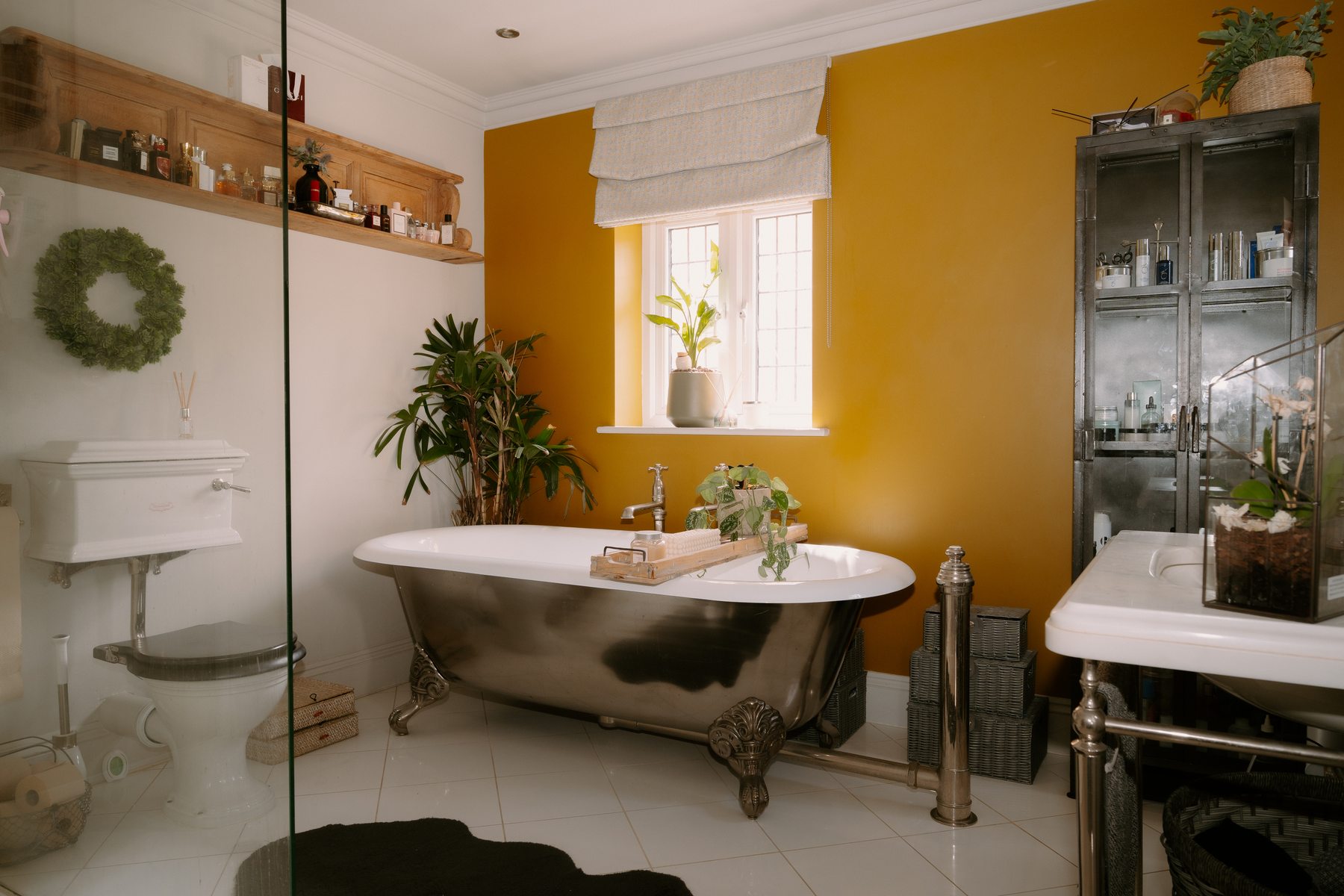 Myrtleberry bathroom with roll-top bath and yellow feature wall