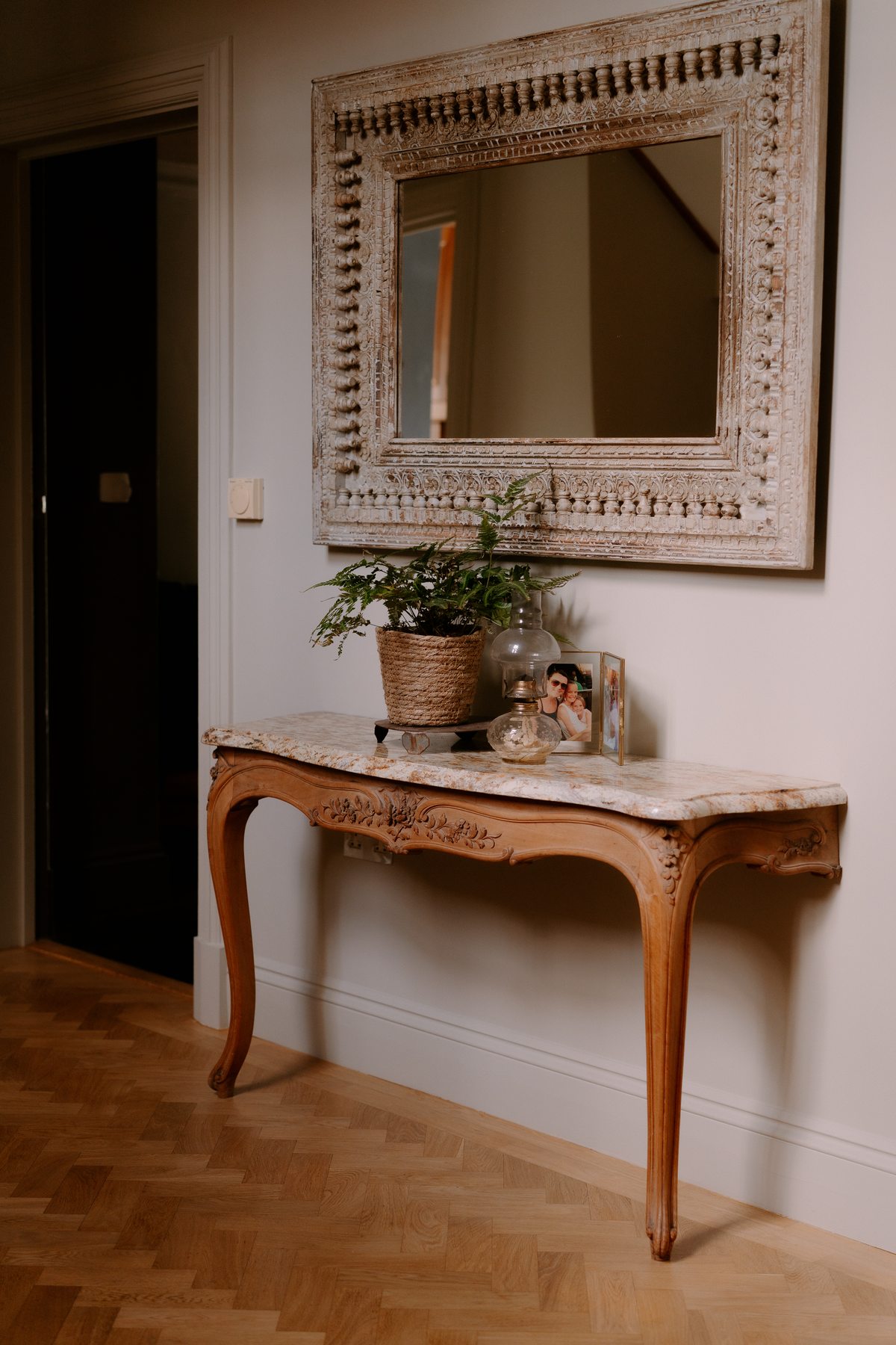 Console table and carved mirror in the hallway