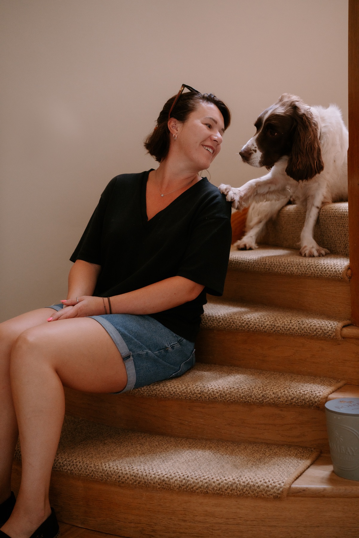Jodie with one of the spaniels on the stairs at Myrtleberry