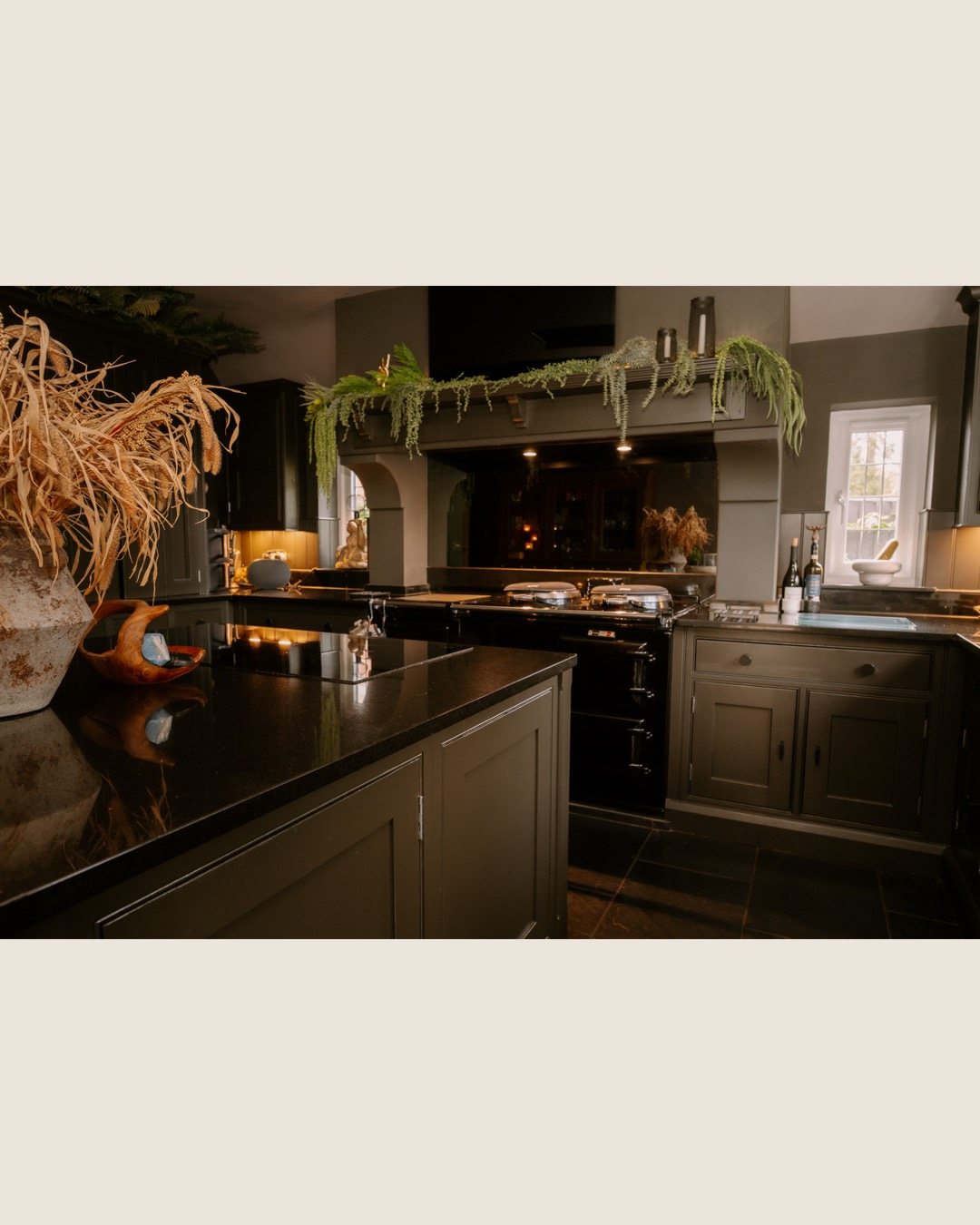 Range cooker and dark cabinetry in the finished kitchen